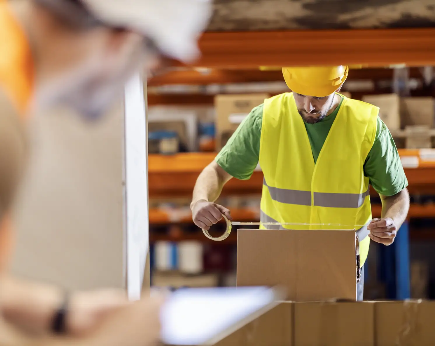 Elye Distribution Warehouse Packing Operations Professional warehouse staff preparing and sealing packages inside Elye Distribution’s logistics facility